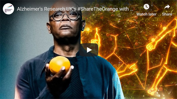 screenshot of Samuel L Jackson's ARUK film. He holds an orange.